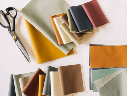 Fabric swatches and scissors on a white table