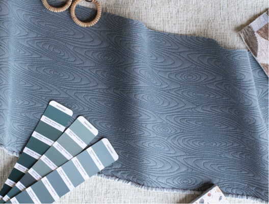 Blue color swatches lying on top of a strip of blue fabric